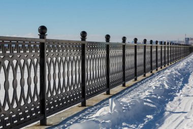 Rıhtımlar üzerinde metal çit. Kış günü.