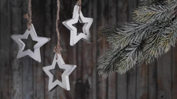 Weihnachtsgirlanden aus Holzsternen auf dem Hintergrund der alten Holzplanken. — Stockvideo