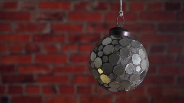 Mirror Christmas ball on the brick wall background. — Stock Video