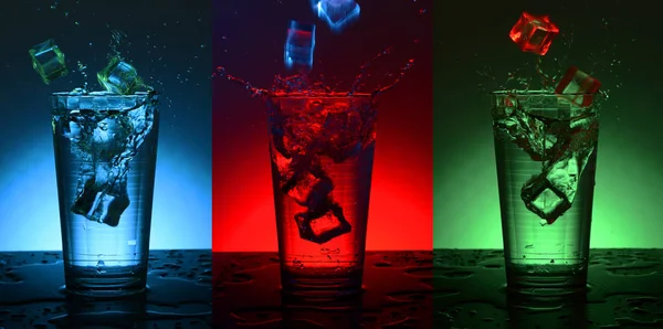 Beautiful splash cocktail with ice. Checkered faceted glass with a cocktail. — Stock Photo, Image