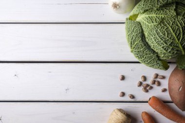 Çorbalar ve Salatalar Beyaz ahşap zemin üzerinde olgun sebze.