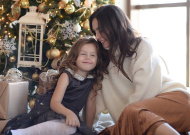 Anne ve kızı Noel ağacında eğleniyorlar, mutlular, gülüyorlar. Yeni yıla makyajlı ve saç stiliyle gireceğiz. Mutlu ve güzel hediyelerle Noel Baba 'yı bekliyor.