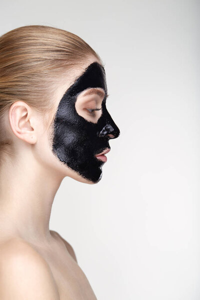 Beauty portrait young woman healthy skin care health white background smile healthcare treatment copy space black mask salve close up