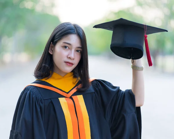 Close Portrait Young Cheerful Female Graduate Wearing Academic Gown Holding — Stock Photo, Image