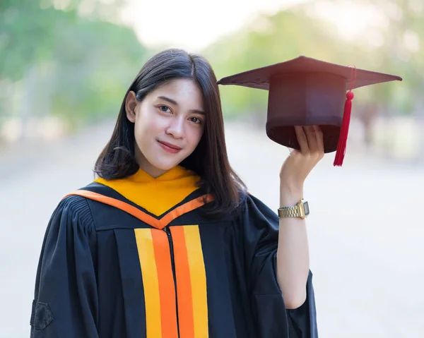 Close Portrait Young Cheerful Female Graduate Wearing Academic Gown Holding — Stock Photo, Image