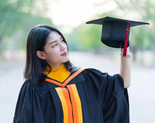 Close Portrait Young Cheerful Female Graduate Wearing Academic Gown Holding — Stock Photo, Image