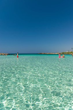 CYPRUS, NISSI BEACH - MAY 12/2018: Tourists relax and swim on one of the most popular beaches on the island.