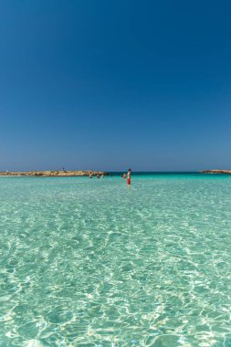 CYPRUS, NISSI BEACH - MAY 12/2018: Tourists relax and swim on one of the most popular beaches on the island.