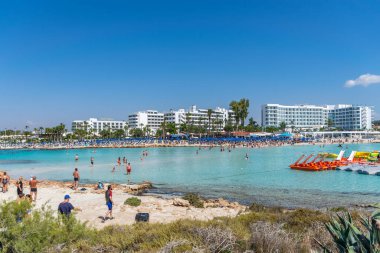 CYPRUS, NISSI BEACH - MAY 12/2018: Tourists relax and swim on one of the most popular beaches on the island.