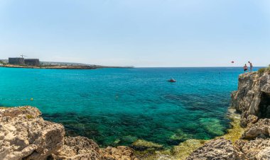 CYPRUS, NISSI BEACH - MAY 12/2018: Tourists relax and swim on one of the most popular beaches on the island.