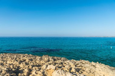 CYPRUS, NISSI BEACH - MAY 12/2018: Tourists swim on catamarans and kayaks in the popular bay of the Mediterranean Sea.