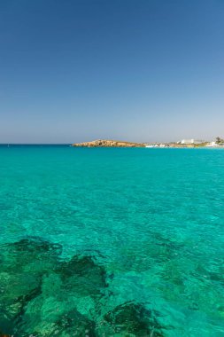 CYPRUS, NISSI BEACH - MAY 12/2018: Tourists relax and swim on one of the most popular beaches on the island.
