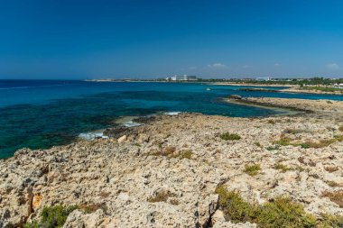CYPRUS, NISSI BEACH - MAY 12/2018: Tourists swim on catamarans and kayaks in the popular bay of the Mediterranean Sea.