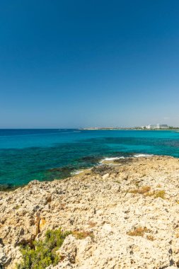 CYPRUS, NISSI BEACH - MAY 12/2018: Tourists swim on catamarans and kayaks in the popular bay of the Mediterranean Sea.