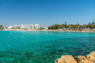 CYPRUS, NISSI BEACH - MAY 12/2018: Tourists relax and swim on one of the most popular beaches on the island.