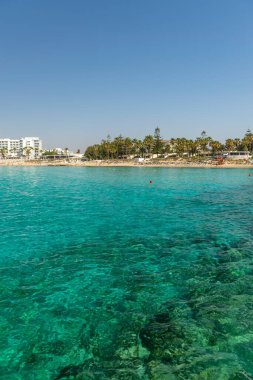 CYPRUS, NISSI BEACH - MAY 12/2018: Tourists relax and swim on one of the most popular beaches on the island.