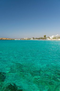 CYPRUS, NISSI BEACH - MAY 12/2018: Tourists relax and swim on one of the most popular beaches on the island.