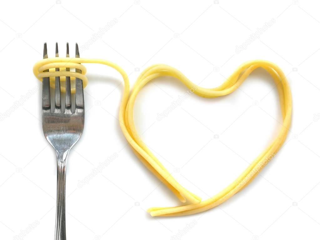 Heart shaped cooked capellini spaghetti with fork 
