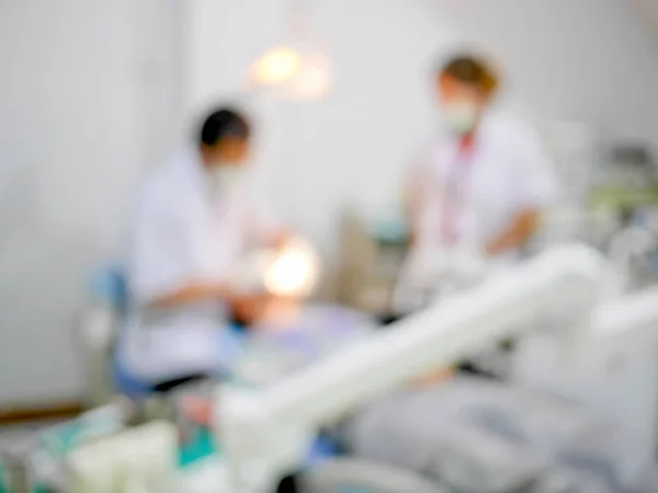 Blurred dentist treating patient
