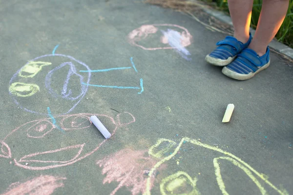 Children\'s drawings in chalk on the pavement