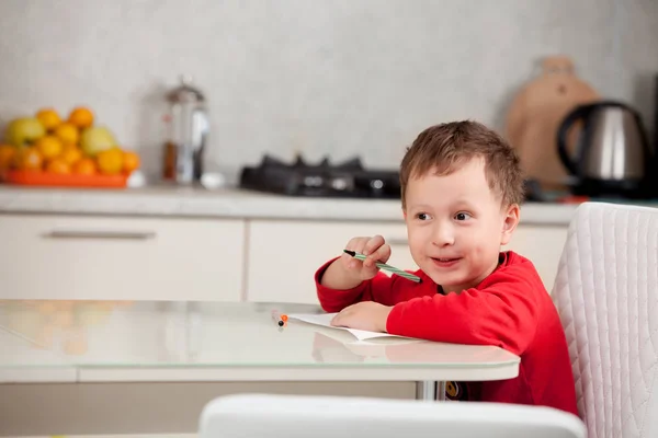 Inspired by the boy draws a picture on the paper at the table