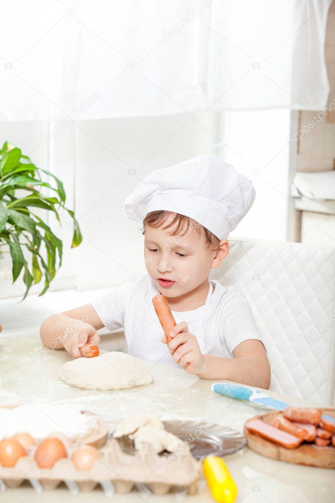 baby knead the dough in flour