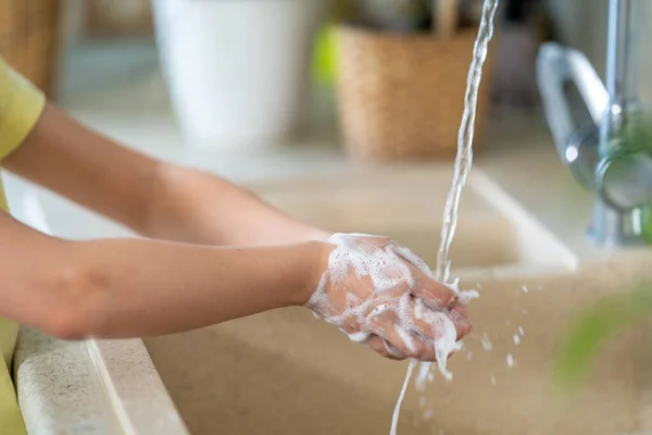 child washes his hands with soap at home. The concept of protection from viruses. hand hygiene. Fight against microbes, viruses, bacteria, covid-19. Stay home. Quarantine. World pandemic.