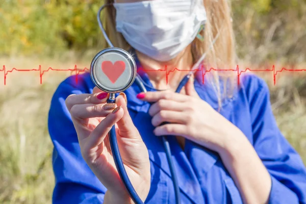 woman doctor with no face fonendoskpom in hands stands on the background