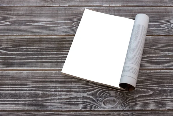 Mock-up female magazine or catalog on a wooden table with flowers. On wood table background. Blank page or notepad for mockups or simulations.