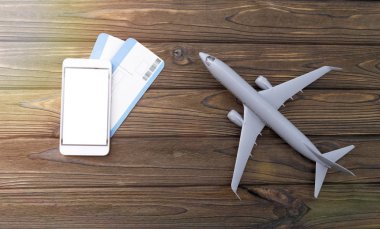 Akıllı telefon, biletler, tahta bir arka planda uçak..