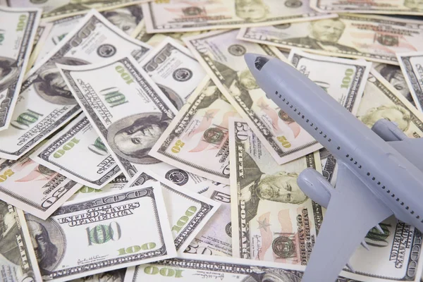 Airplane on Money, the rising costs of airline travel. airline business