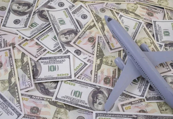 Airplane on Money, the rising costs of airline travel. airline business
