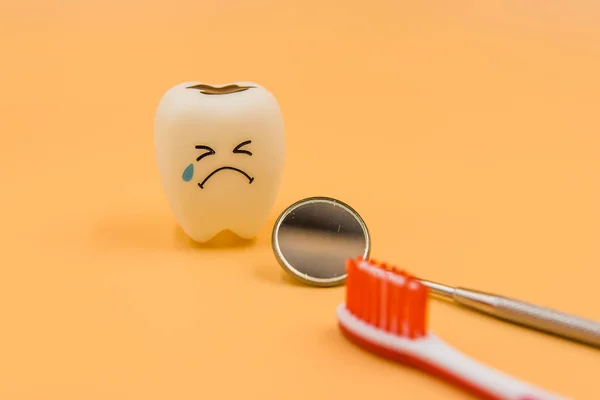 Model Cute toys teeth in dentistry on a yellow background