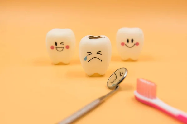Model Cute toys teeth in dentistry on a yellow background