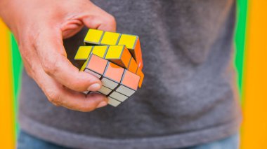  Rubik küp bulmaca erkeklerin elinde. Küp bir Macar mimar Erno Rubik tarafından 1974 yılında icat edilmiştir.