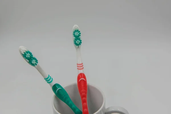Toothbrushes in glass  isolated on a white background — Stock Photo, Image