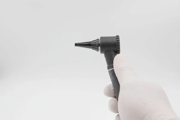 Otoscope  in hand doctor on the white background . medical equipment — Stock Photo, Image