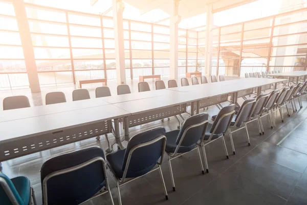 Long Conference table and chairs . Before conference in the boardroom office interior .