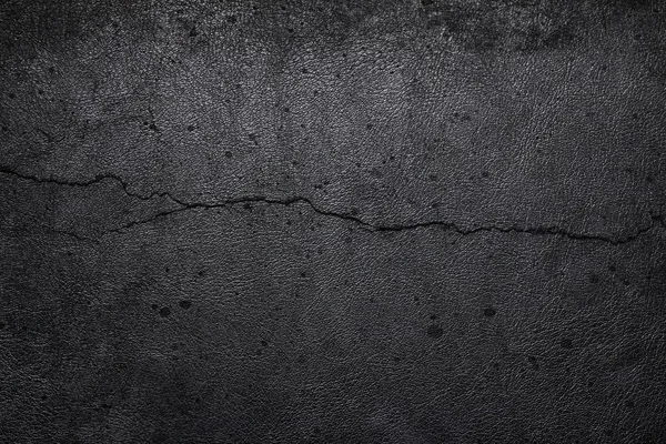 Cement background with cracked leather