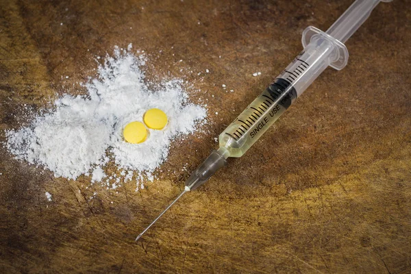 Spritze und Heroin auf Holzgrund mit Schattenrand. Drogensucht — Stockfoto