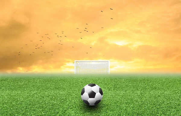 Bola de futebol no pôr-do-sol grama — Fotografia de Stock