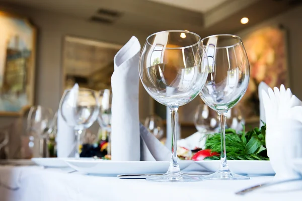 Restaurant tafel met glazen en servetten — Stockfoto