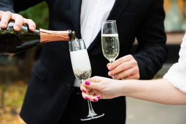 Şampanyayı bardağa dolduruyorum