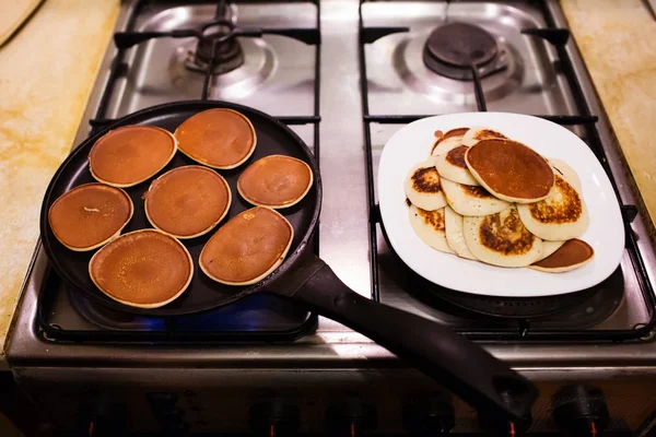 Making pancakes in a black pan. Shrovetide, pancake week — Stock Photo, Image