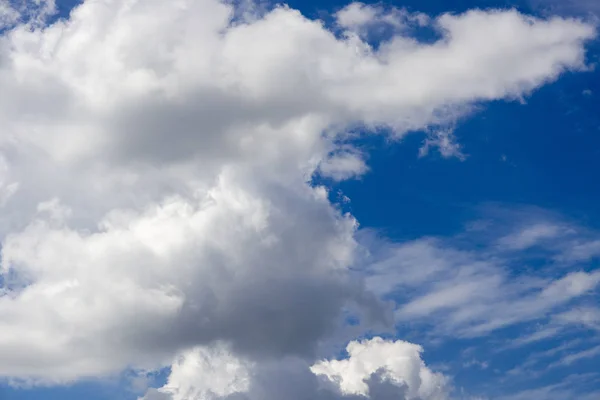 Aerial clouds against a blue sky at noon