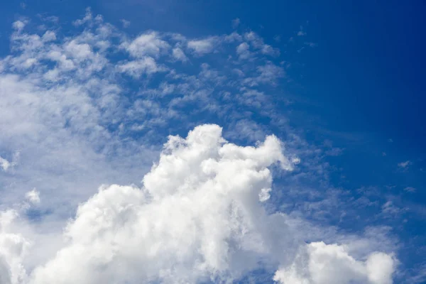 Aerial clouds against a blue sky at noon