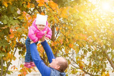Baba kızıyla parkta oynuyor.