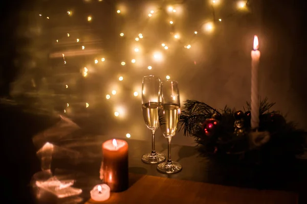 Masadaki Noel Şampanyası Arka Plandaki Çelenklere Karşı — Stok fotoğraf