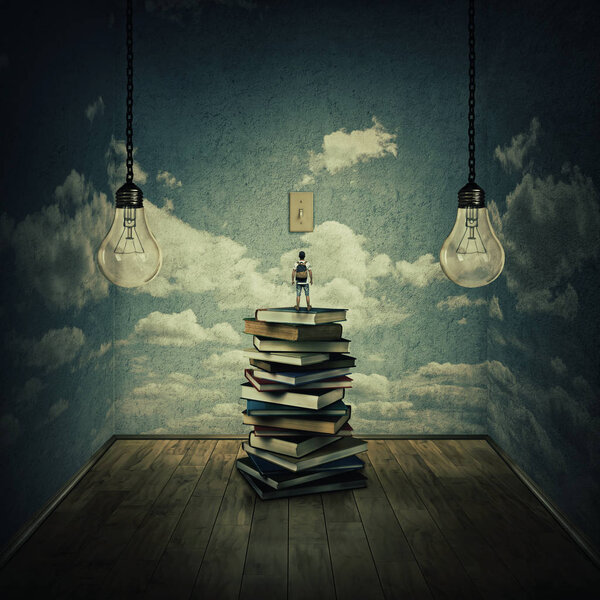 Idea concept with a boy standing on a pile of books trying to switch on the light bulbs, surrounded by concrete walls with clouds texture as thinking limitations. In search of knowledge.
