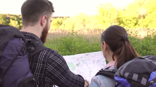 Close-up of two tourists with backpacks and map. — Stock Footage Close-up of two tourists with backpacks and map. Stock Video